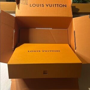 Louis Vuitton Signature Box inside a LV shipping box with tissue and ribbon.